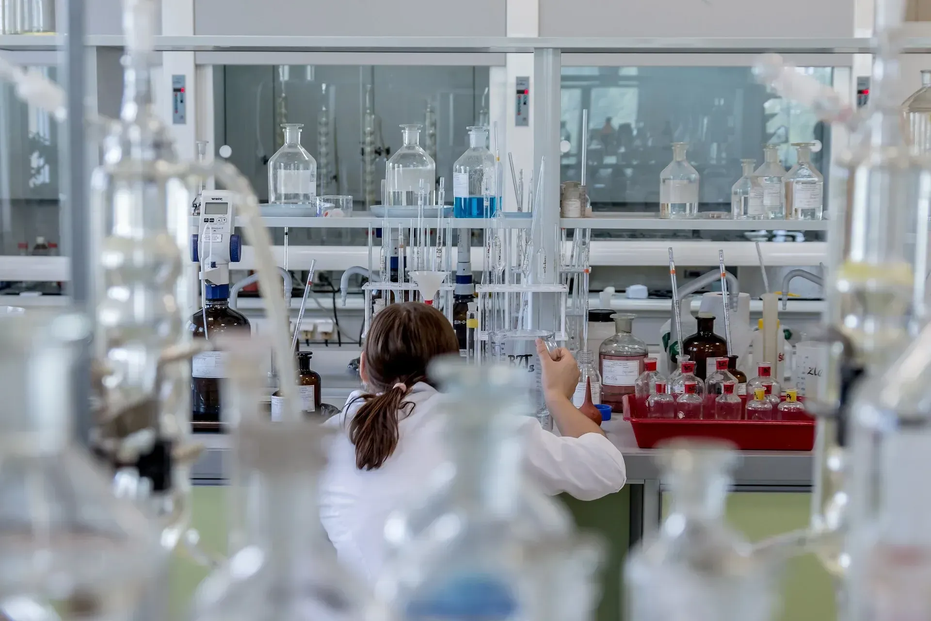 Laboratory technician working among glassware